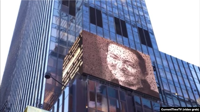 Alsu Kurmasheva's face pictured on a billboard on the side of a building.