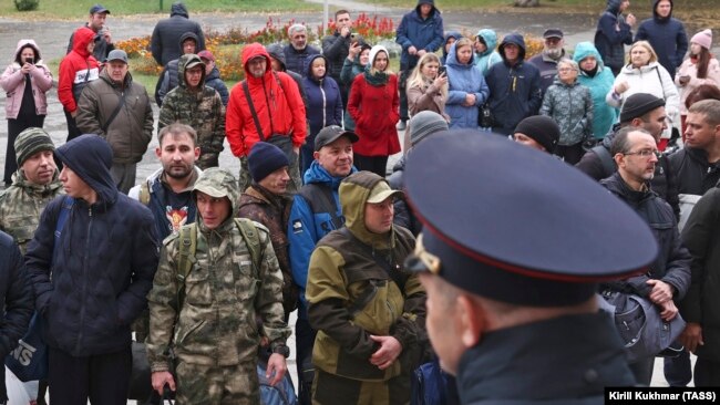 Mobilized men gather by a military commissariat of the Kirovsky and Leninsky Districts of Novosibirsk.