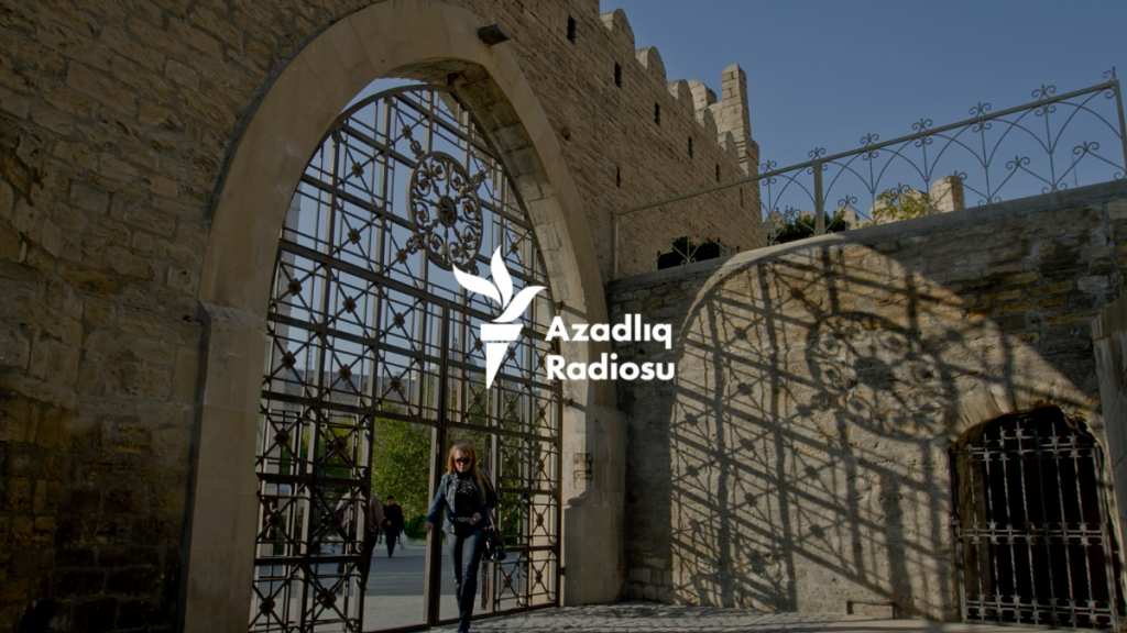 An image of the Azerbaijani RFE/RL logo superimposed on an image of an old stone building