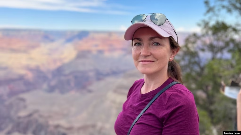 An image of Alsu Kurmasheva standing in front of the Grand Canyon