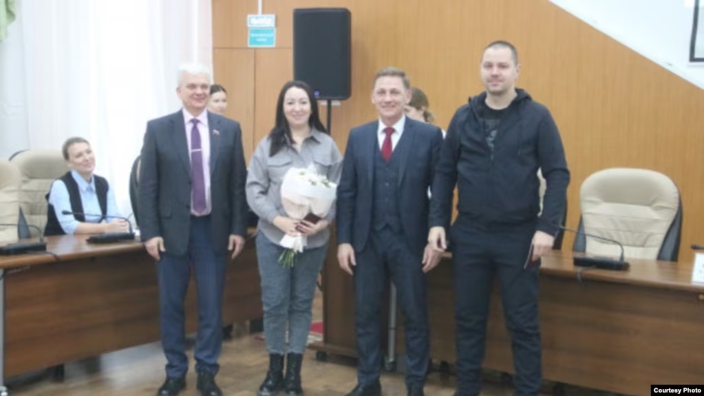 Pavel Kontorbaev receives his Russian passport in the city of Berdsk, Russia. (Courtesy Photo).