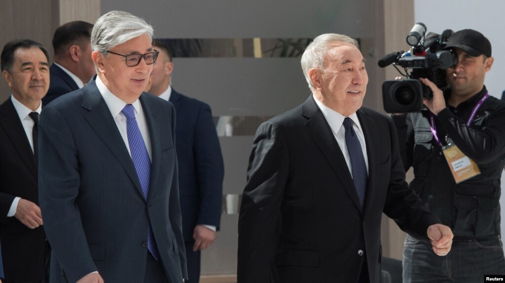 Kazakh interim President Kassym-Jomart Tokayev (L) and former President Nursultan Nazarbayev (R) attend the Astana Economic Forum in Nur-Sultan, Kazakhstan.