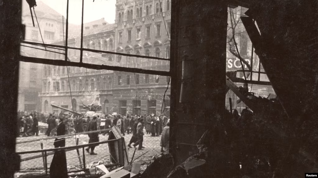 Hungarians walk on the destroyed streets of Budapest during the 1956 uprising against the Soviet-supported Hungarian communist regime.