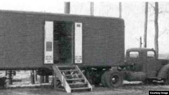 A black and white image of a parked trailer that made up part of Barbara's ecosystem.